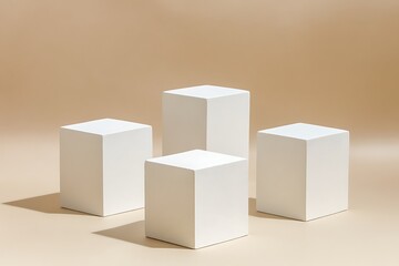 Four White Cubic Display Stands Against a Light Beige Background