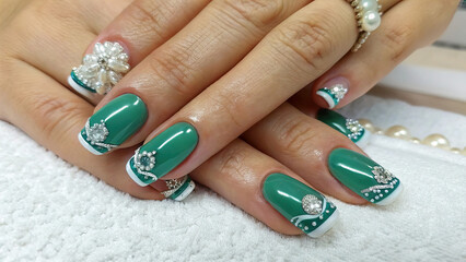 Fingers of young woman's hand with beautiful French pearl nail polish, Creative manicure with gel polish in luxury beauty salon, Nail art and design, French manicure