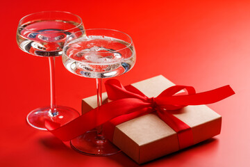 A glasses of champagne elegantly paired with a gift box