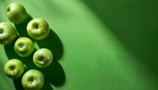 Green background with green apples and copyspace.