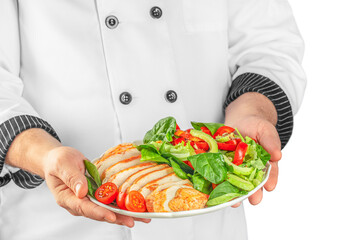 Chef hands preparing delicious avocado salad with grilled chicken fillet isolated on white background