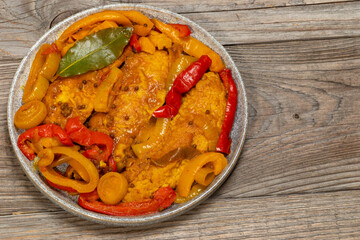 Top view of marinated sweet and sour fish with vegetables on a plate. Copy space. 