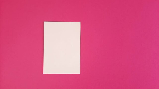 Blank white sheet of paper, Stop motion animation, page template moving in circle, dancing with space for text on pink background