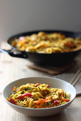 Bowl of stir fry vegetables and noodles, served on the table. Selective focus.