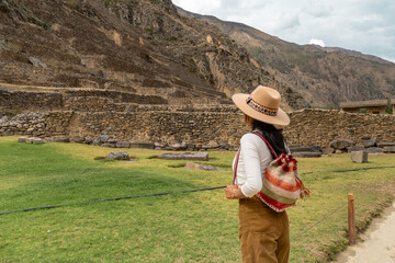 Latin tourist looking at the terraces of the Ollantaytambo fortress