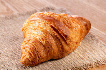 Croissant on the kitchen table, top view, close-up