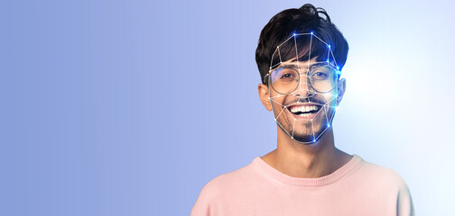 A young man smiles while his face is scanned by advanced facial recognition technology. The background is plain, highlighting the innovative aspect of identification through modern methods.