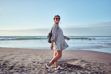 adult woman walking on the beach enjoying summer vacation