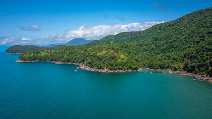Fototapeta premium Beautiful aerial view of a preserved area, Fazenda Beach, within the Serra do Mar State Park, a destination for sustainable and ecological tourism in Atlantic Rainforest, between Montains and Sea.
