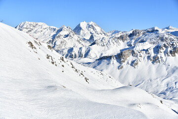 French alps on a sunny day by winter covered with snow