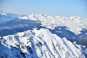 French alps on a sunny day by winter covered with snow