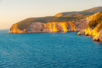 Lighthouse on the cliff. Seascape of Cape Lefkatas with old lighthouse on Lefkada island, Greece....