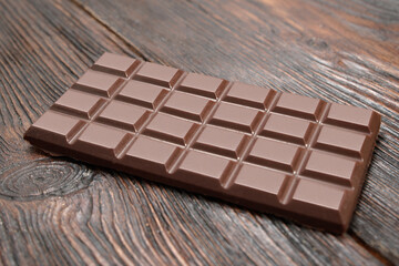 Broken dark chocolate on a wooden table