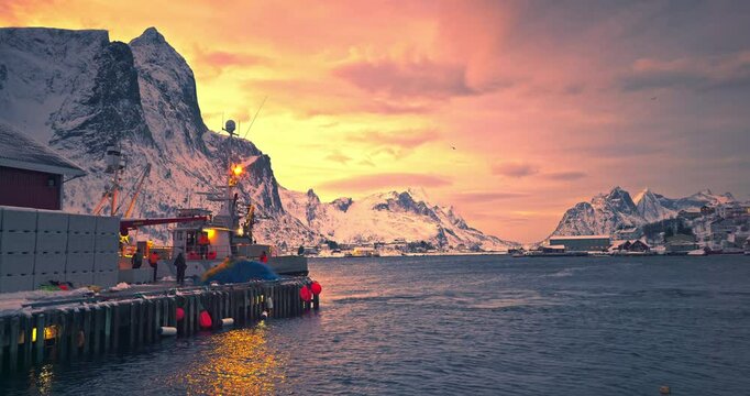 Fishermen and arctic fishing ship on Nordic sea harbour,Lofoten,Norway