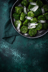 Frozen spinach green cubes in bowl
