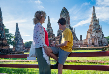 Family exploring the ancient ruins of Wat Chaiwatthanaram in Ayutthaya, Thailand, bonding while...
