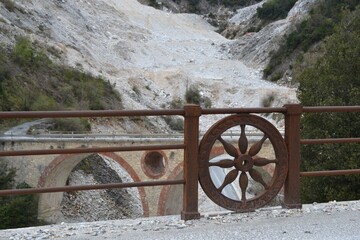 Fototapeta premium Historic stone bridge with artistic railing in a rocky landscape