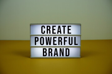 Create Powerful Brand text on LED lightbox with alarm clock on yellow background