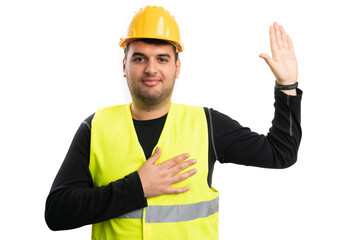 Serious constructor man making honest oath gesture with palm