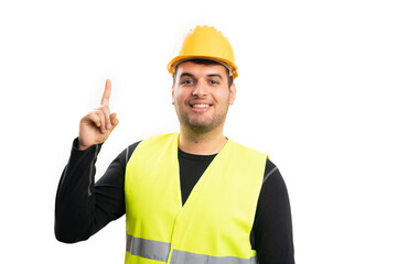 Builder in work attire smiling making idea gesture with finger