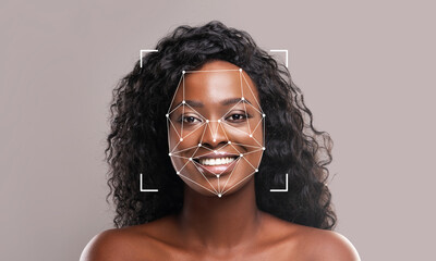 A young woman with curly hair smiles confidently. Geometric lines outline her face, illustrating...