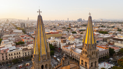 Fototapeta premium Guadalajara cathedral towers rising above downtown skyline at sunset. Jalisco, Mexico