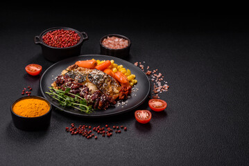 Grilled mackerel fillet pieces with vegetables, salt and spices