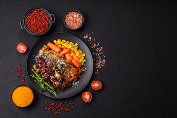 Grilled mackerel fillet pieces with vegetables, salt and spices