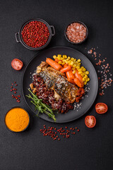 Grilled mackerel fillet pieces with vegetables, salt and spices