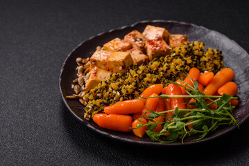 Quinoa bowl with tofu, steamed vegetables, grains, seeds and spices