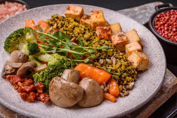 Quinoa bowl with tofu, steamed vegetables, grains, seeds and spices