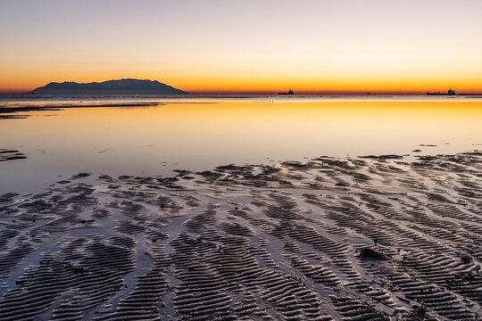 Beautiful sunset or sunrise on the Apalos beach, Alexandroupolis. View to Samothrace or Samothraki island, seaside and tourist destination