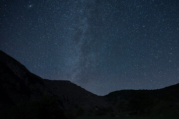Beautiful night landscape, Bright Milky Way galaxy over the mountains, starry sky.
