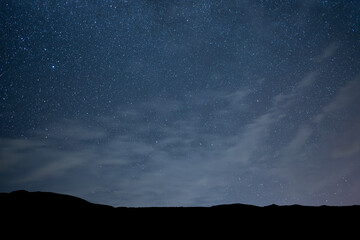 Beautiful night landscape, Bright Milky Way galaxy over the mountains, starry sky.