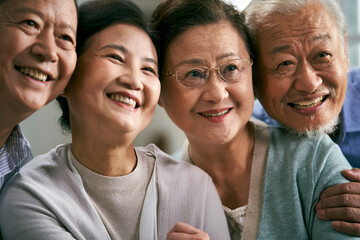 close-up portrait of two happy smiling senior asian couples