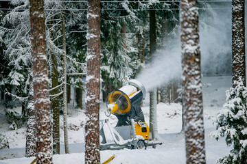 Naklejka premium Snow cannon working in ski resort for ski slopes to blow and creat more artificial snow
