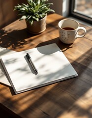 A notebook and a pen next to a plant and a cup of coffee on a wooden desk