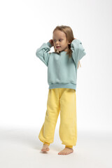 Portrait of beautiful cute little toddler girl. Child with funny face. Pretty smile kid in studio on white background. High quality photo