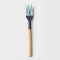 A sleek fork with a blue silicone tip and a polished wooden handle, offering an eco-friendly and modern design for sustainable dining