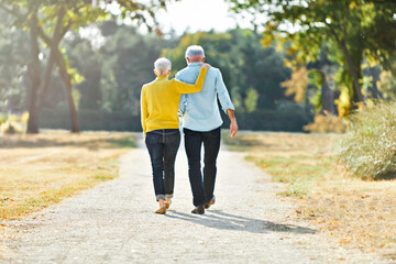 Fototapeta premium woman man outdoor senior couple retirement together walking love holding hands support old nature wife happiness mature elderly