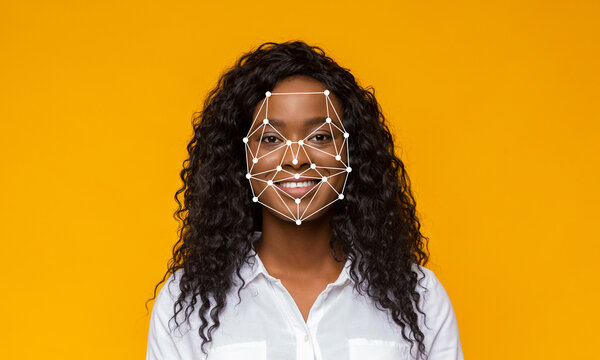 A young woman smiles directly at the camera as advanced facial recognition technology highlights her facial features against a bright yellow backdrop. The scene emphasizes identification.