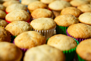 Rows and rows of mini banana muffins on a kitchen table