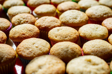 Rows and rows of mini banana muffins on a kitchen table