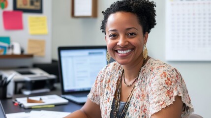 Smiling african female adult in office setting with computer in background