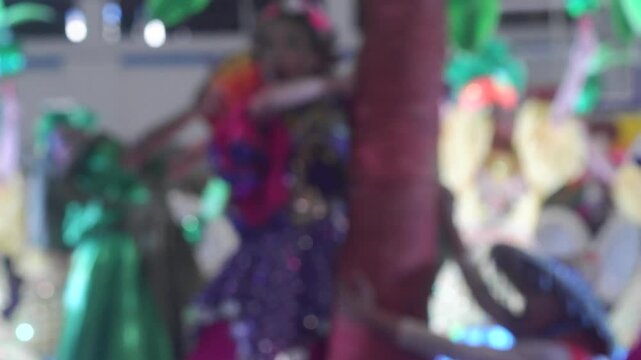 Dancers in colorful native costumes perform exuberantly to honor a Patron Saint during the annual coconut festival celebration. Blurs