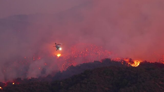 A heroic helicopter battles a massive fire in Malibu, Los Angeles, showcasing the dedication of all those fighting against this devastating disaster and its consequences. January 7, 8, 9, 2025