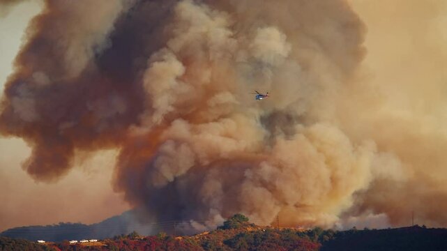 A sequence captures a massive fire in Malibu, Los Angeles, in January 7, 8, 9, 2025, as helicopters bravely fight fierce flames amid thick, dramatic smoke rising into the sky