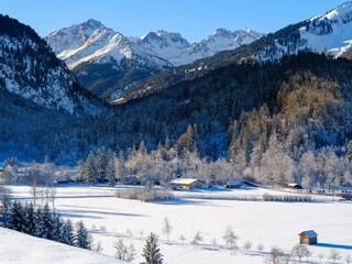 View over the basin of Oberstdorf towards valley Stillachtal, Mt. Biberkopf, Mt. Hochrappen. The Allgau Alps near Oberstdorf during winter in Bavaria, Germany.
