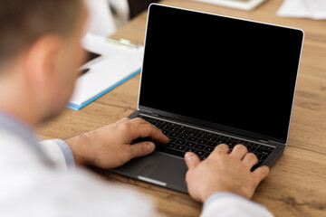 Lifestyle And Modern Technology Concept. Man using laptop with blank black screen for mock up...