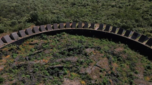 Drone shot over Espacio Escultorico UNAM with green surroundings on a sunny day